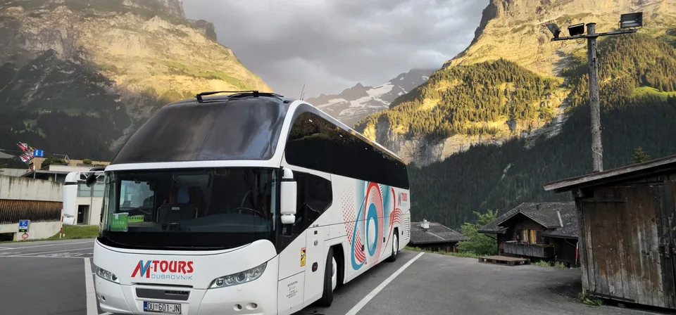 Touring coach surrounded by mountains